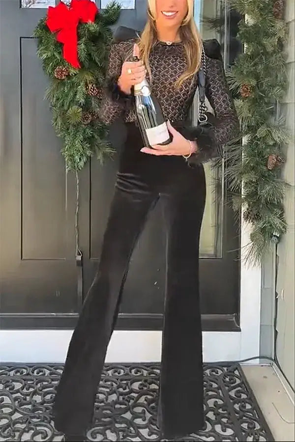 Women's black velvet jumpsuit with sheer lace long sleeves and wide-leg pants.