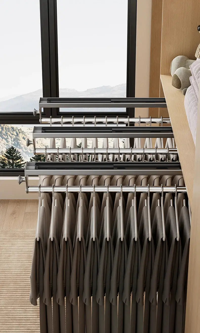 Pull-out trouser hanger system with multiple chrome rails and beige hangers in a closet
