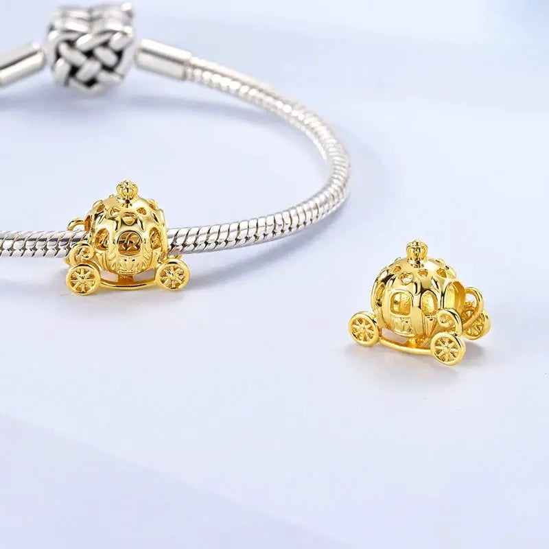 Gold-tone carriage charm bead for bracelets with intricate wheel-and-carriage design