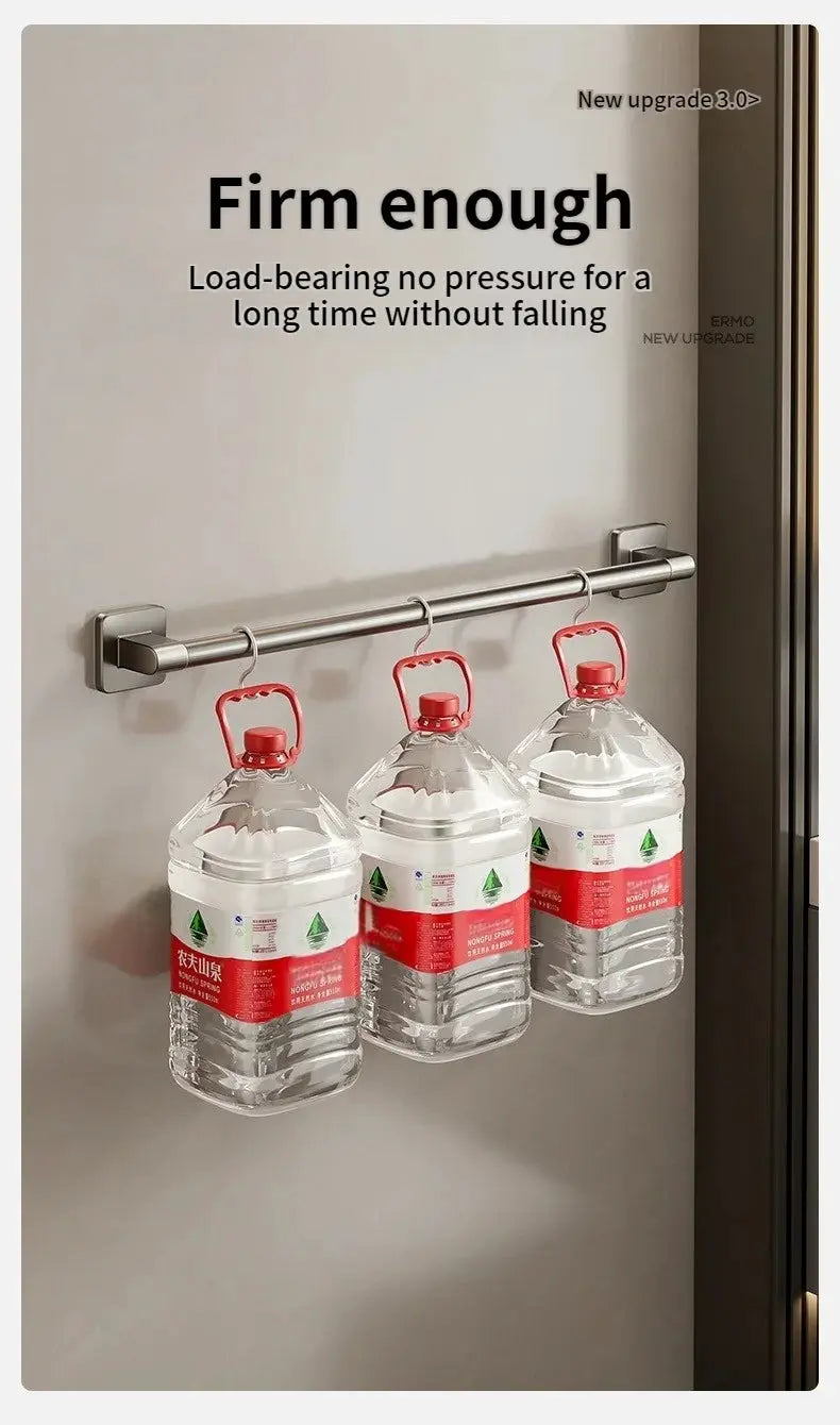 No-drill bathroom towel bar rack; stainless steel wall-mounted rod with end brackets holding 3 red-capped water bottles