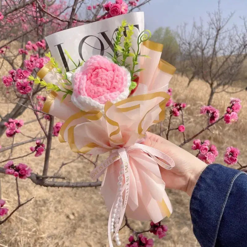 Stuffed plants bouquet by Simples Market; pink and white handmade flowers with pink tissue wrap and gold ribbons.