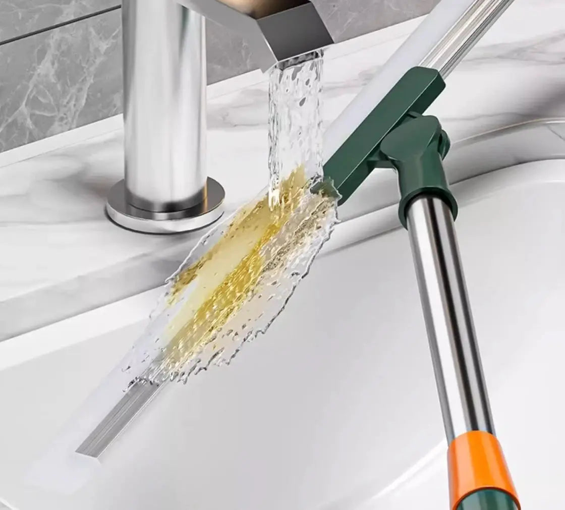 Silicone scraper broom wiper cleaning tool by Simples Market, green hinge, orange handle
