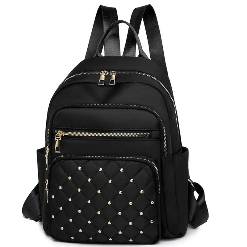 Travel backpack in black with a quilted front pocket, gold zippers, and large-capacity multi-pocket design.