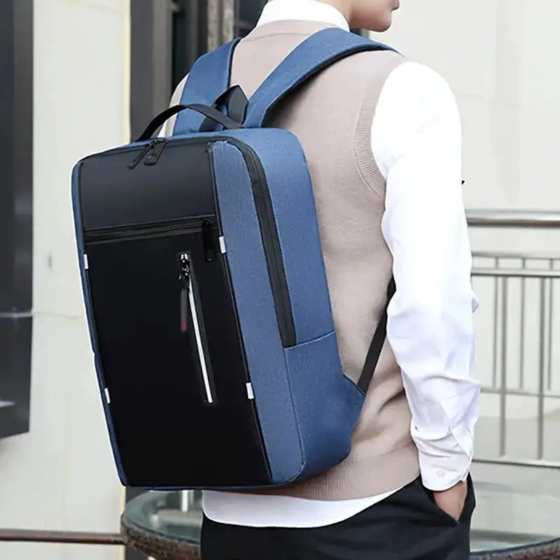 Neutral-style schoolbag backpack by Simples Market in blue with black front panel for business, industrial use travel.
