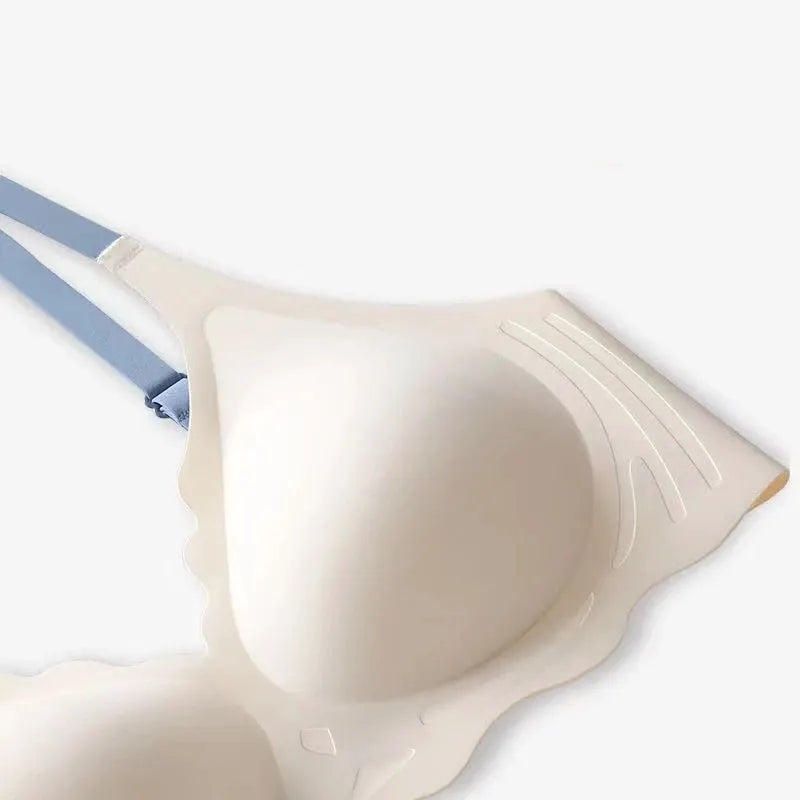 Beige molded-cup bra with light blue adjustable straps and subtle back support panels