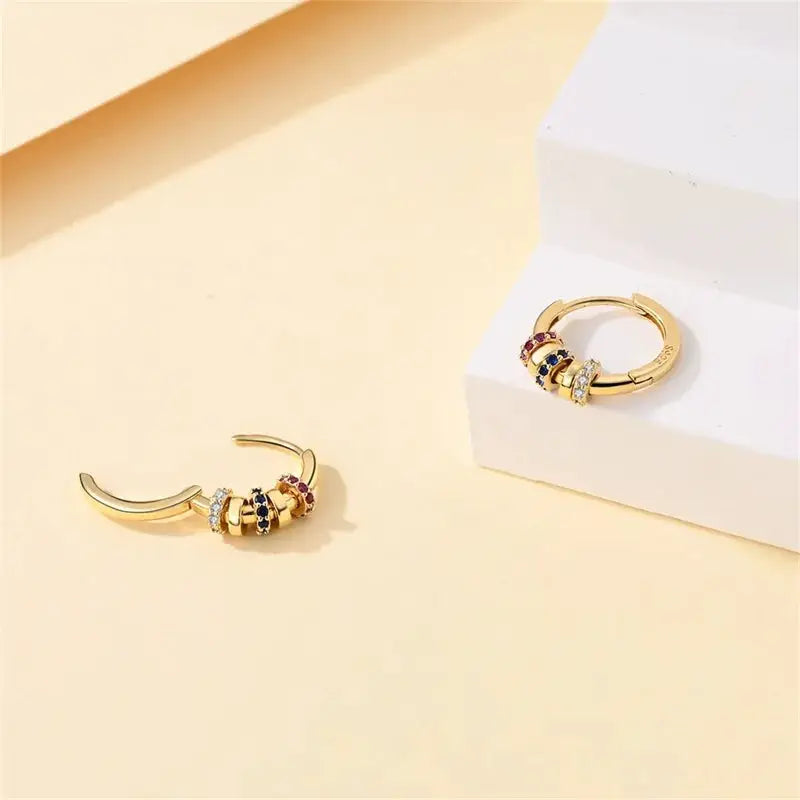 Pair of gold-tone hoop earrings with stacked multicolor stones and crystals