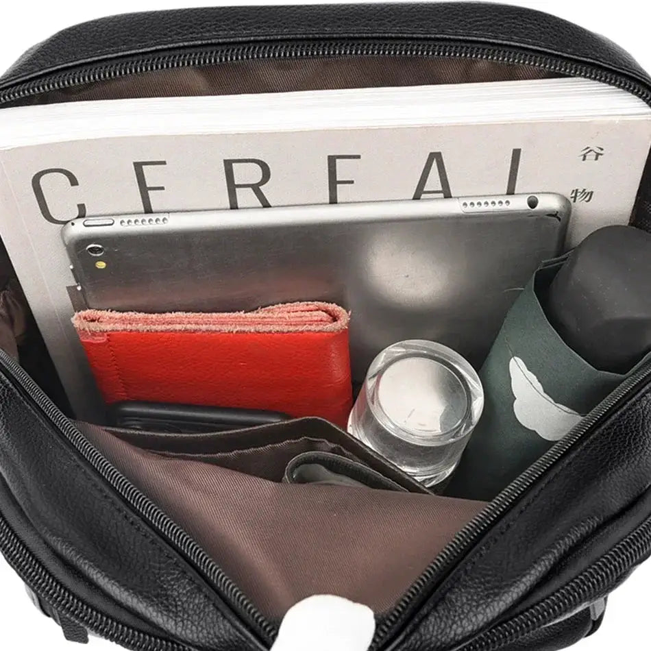 Black leather women's backpack, large-capacity, opened to reveal red wallet and tablet inside