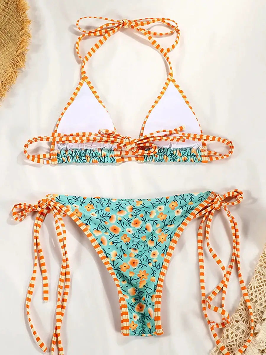 Two-piece bikini set by Simples Market, turquoise floral print with orange striped ties.