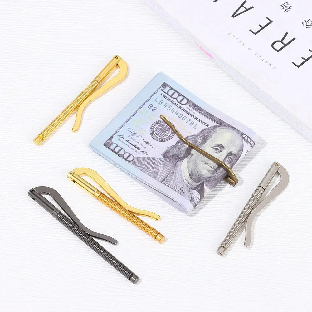 Set of four metal money clips with spring clamps in gold, silver, and gunmetal tones around a stack of $100 bills