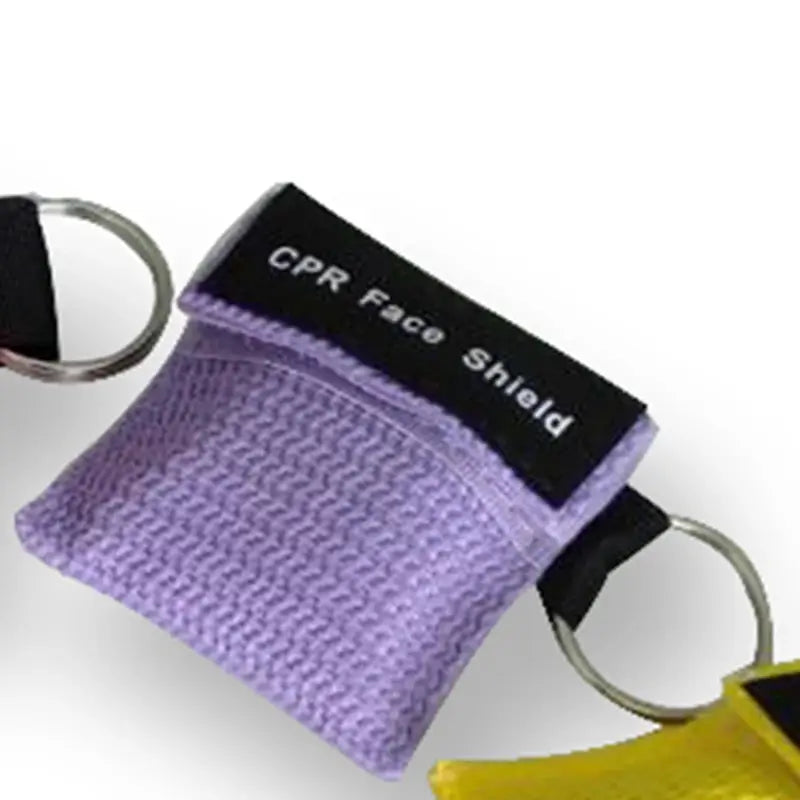 Keychain CPR face shield in a purple fabric pouch with black label and dual metal rings