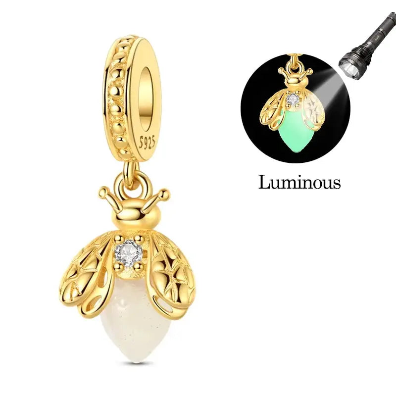 Gold-tone 925 sterling silver charm pendant with filigree wings and white teardrop bead