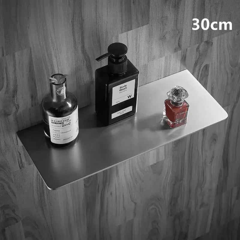 304 stainless steel brushed chrome corner bathroom shelf, 30cm, wall-mounted, with three bottles on it.