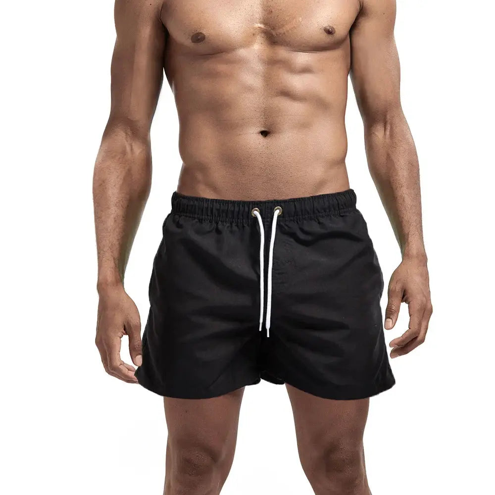 Men's black swim shorts with white drawstring, quick-dry board shorts for surfing and beach.