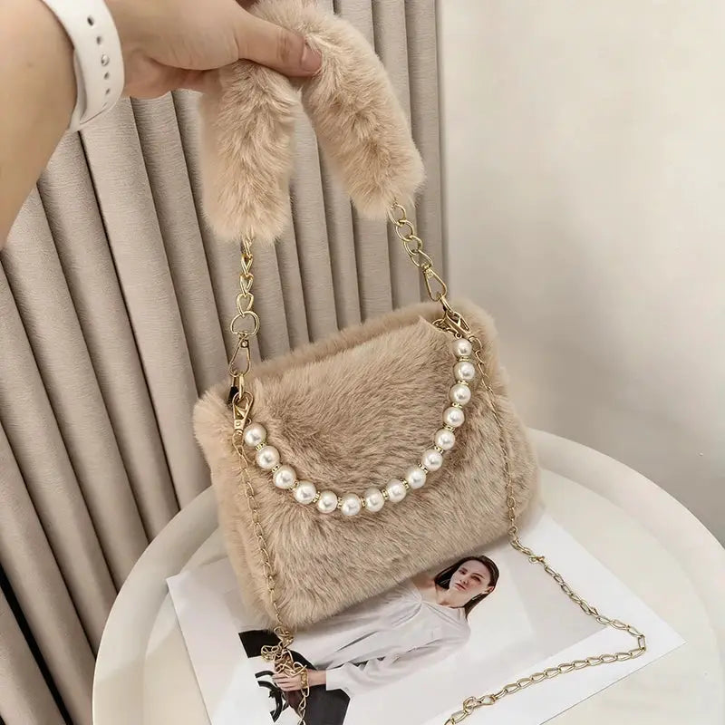 Fashionable pearl rabbit-fur handbag by Simples Market; beige crossbody with pearl trim and gold chain strap.