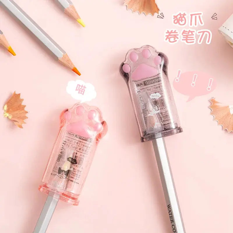 Kawaii cat paw pencil sharpener pair, pink and purple translucent plastic, Korean stationery.