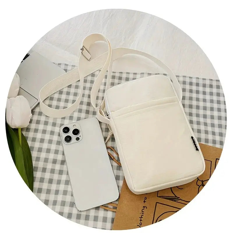 New Fashion Simple Casual Shoulder Messenger Bag by Simples Market, beige with adjustable strap beside a smartphone.