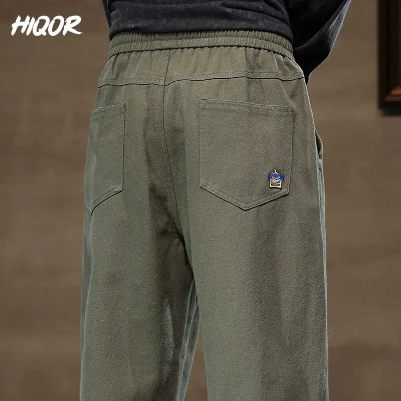 HIQOR men's olive cotton cargo pants with elastic waistband and back pockets.