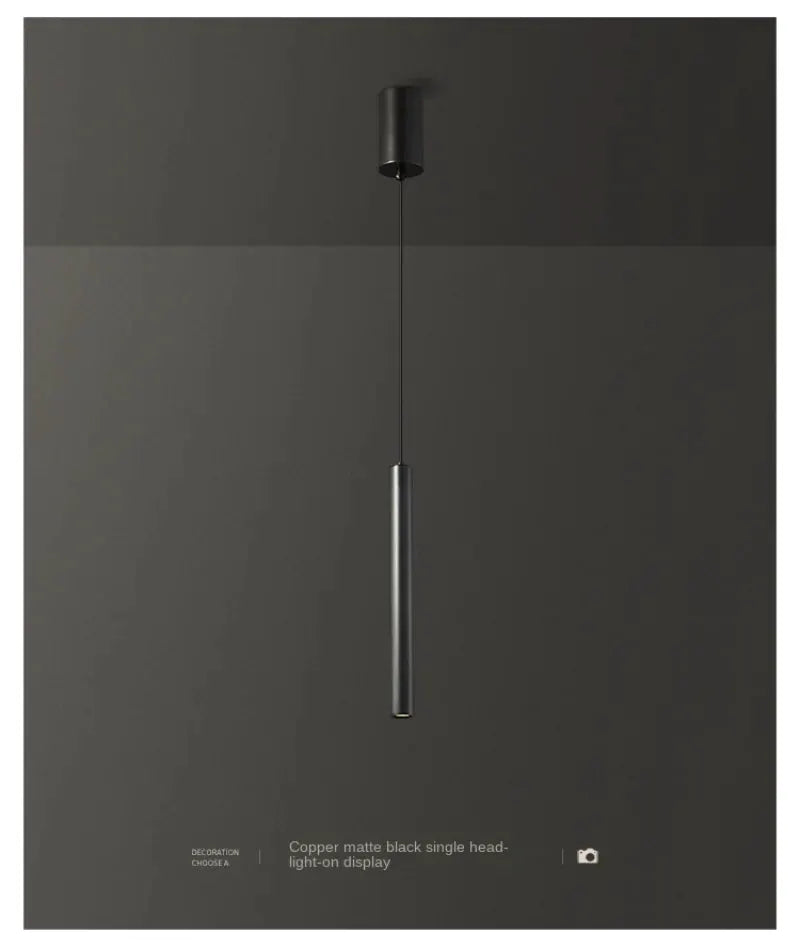 Minimalist pendant lamp copper matte black with a single vertical cylindrical light hanging from the ceiling