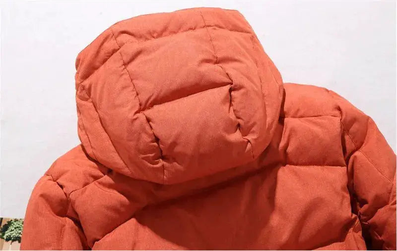 Men's orange hooded down parka by Simples Market with quilted padding and thick insulation.