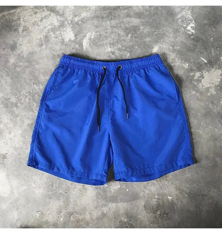Blue men's swim shorts with black drawstring and elastic waistband.