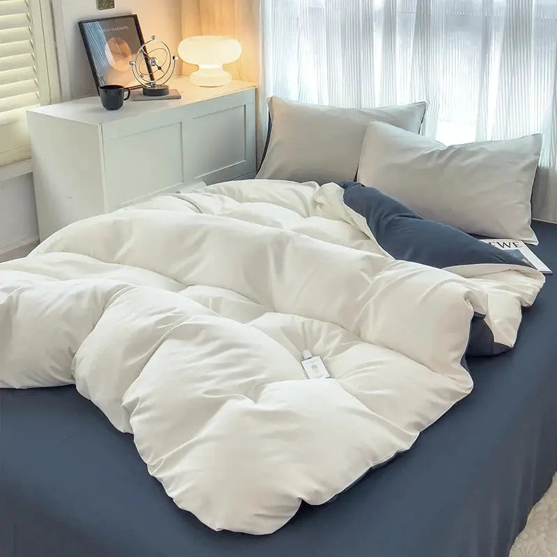 4-piece brush-fabric bed set with ivory duvet cover, light-gray pillowcases on navy sheet