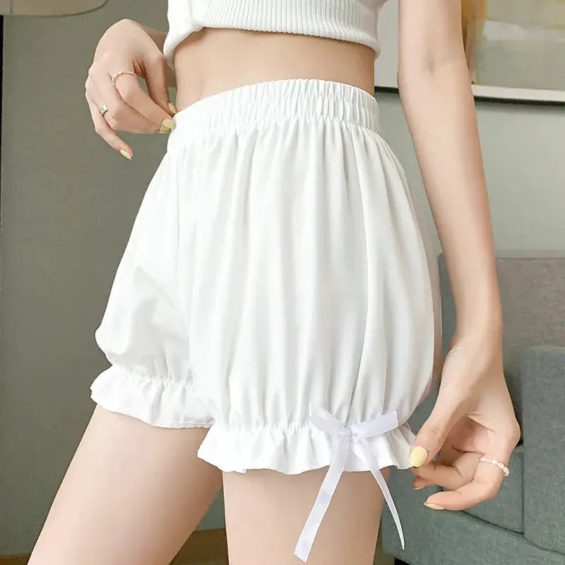 White satin bloomers with elastic waist, ruffled hem, and bow detail