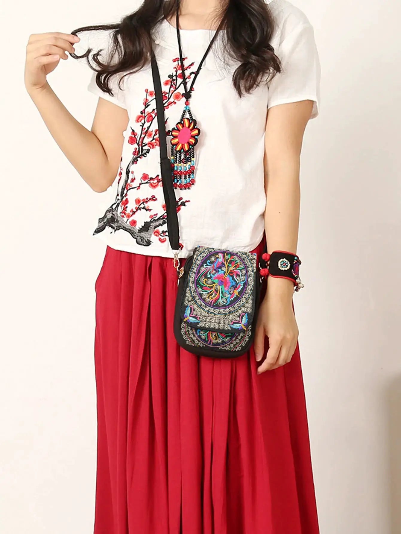 Stylish women's embroidered crossbody phone bag; small black canvas with colorful embroidery