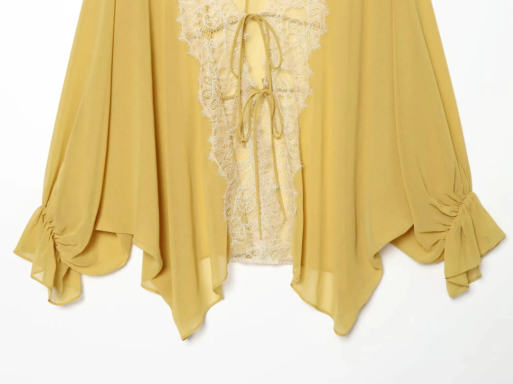 Women's mustard-yellow lace-patchwork lantern-sleeve blouse with tie-up front and sheer fabric.