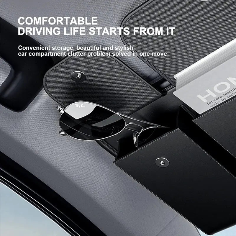 Car sun visor organizer in black leather with multiple pockets for sunglasses and cards.