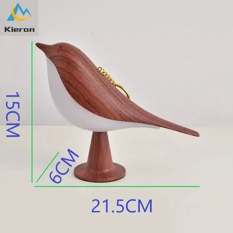Magpie LED desk lamp, wood-textured brown bird on white body with pedestal base; Simples Market, Kieron logo