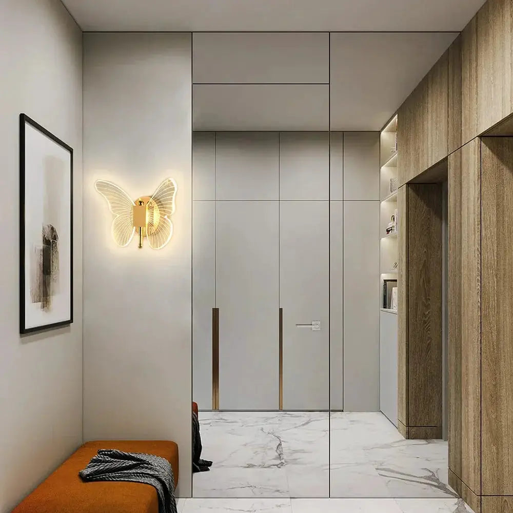 Butterfly LED wall lamp in gold metal with acrylic wings; warm light wall sconce