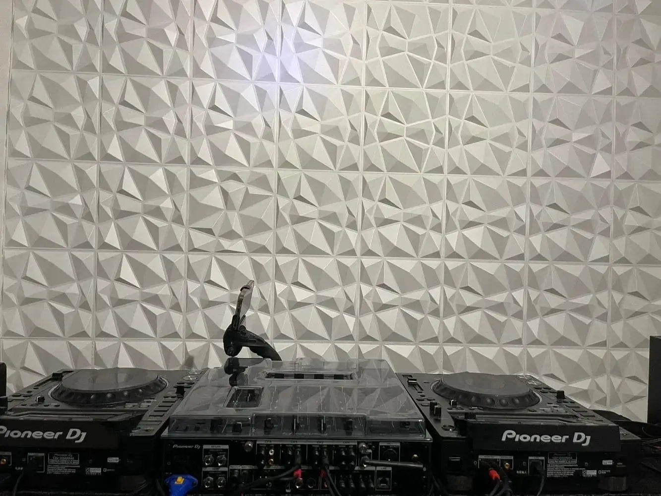 10pcs 30x30cm 3D wall panels with geometric pattern, white-gray decor, shown behind Pioneer DJ equipment.