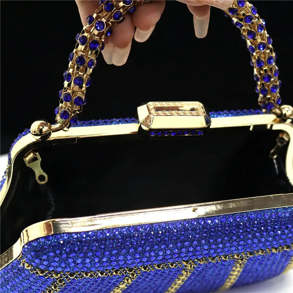 Evening clutch with blue rhinestone embellishment, gold-tone frame, and long chain by Simples Market