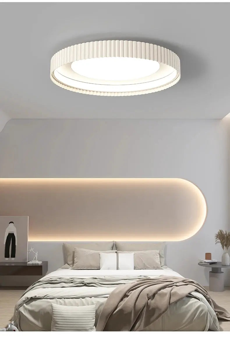Modern round metal LED ceiling light with a ribbed white outer ring, ideal for bedroom decor.