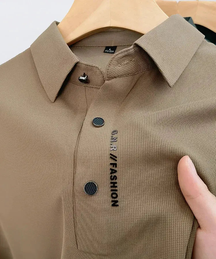 Beige short-sleeve polo shirt with collar and textured knit, black vertical FASHION lettering on chest