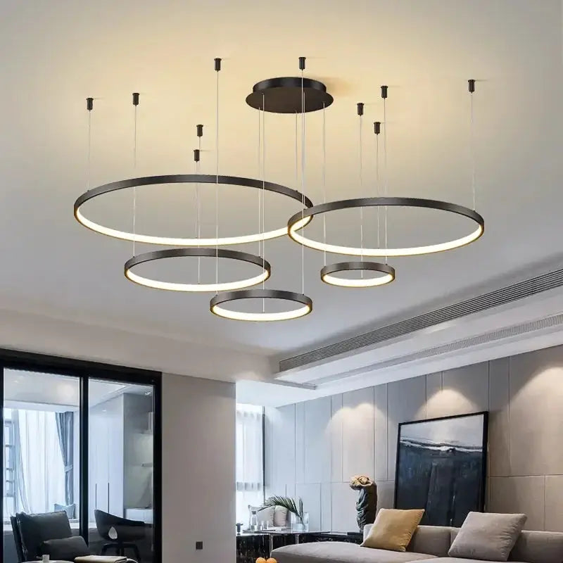Modern circular LED ring pendant chandelier set with multiple black rings and warm white glow
