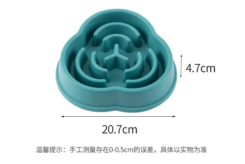 Teal slow-feed pet bowl with maze-like interior ridges, round shape, and non-slip base.