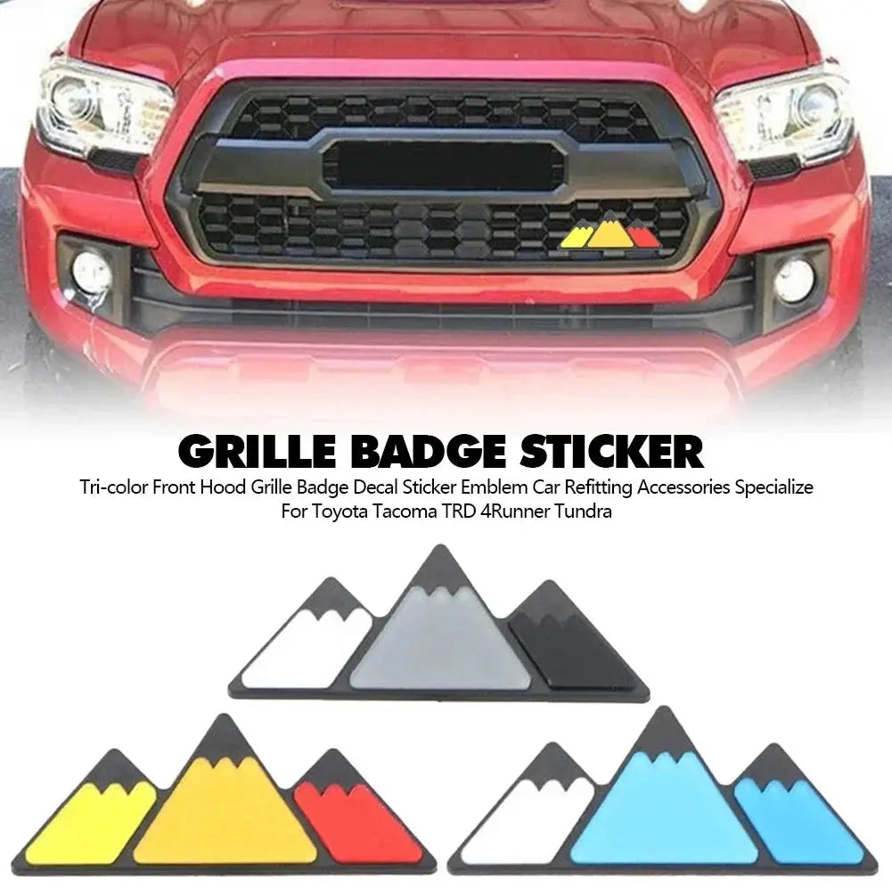 Grille badge sticker set for Toyota trucks with tri-color mountain emblem in yellow, red and blue.