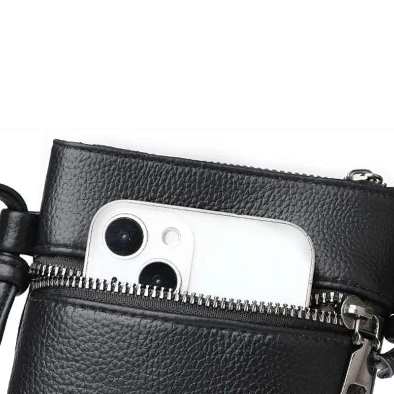 Simples Market PU leather diagonal cross bag in black with front zipper pocket and visible phone.