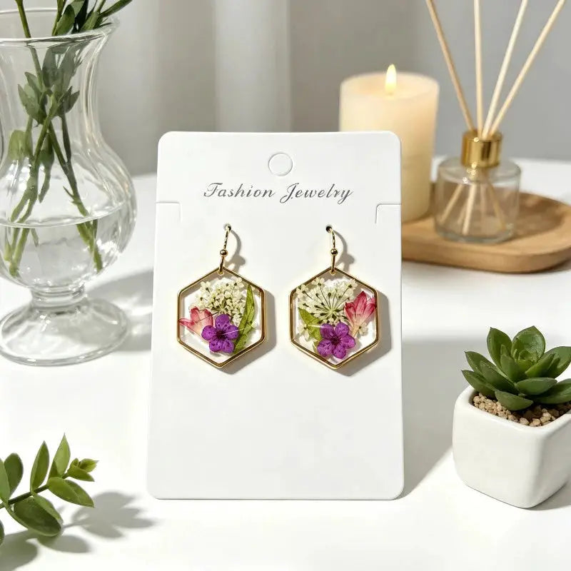 Pair of hexagonal epoxy resin earrings with pressed flowers, gold-tone frames, purple blossoms, Simples Market fashion jewelry