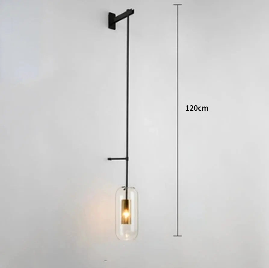 Modern glass wall light sconce by Simples Market with clear cylinder shade and black metal mount, 120 cm