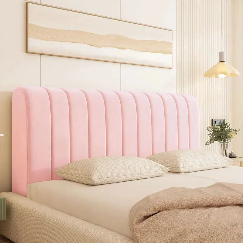 Pink velvet headboard cover with vertical channel tufting for a stylish bed in a beige-toned modern bedroom.