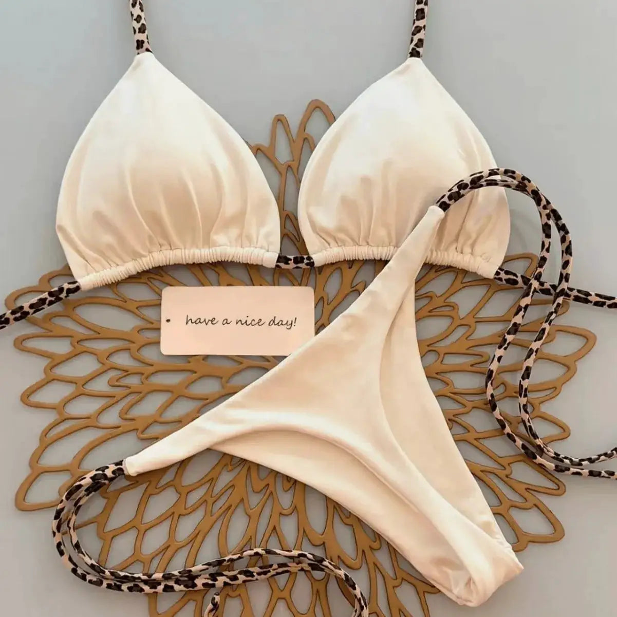 Simples Market beige triangle-top bikini set with leopard-print straps and thong bottoms