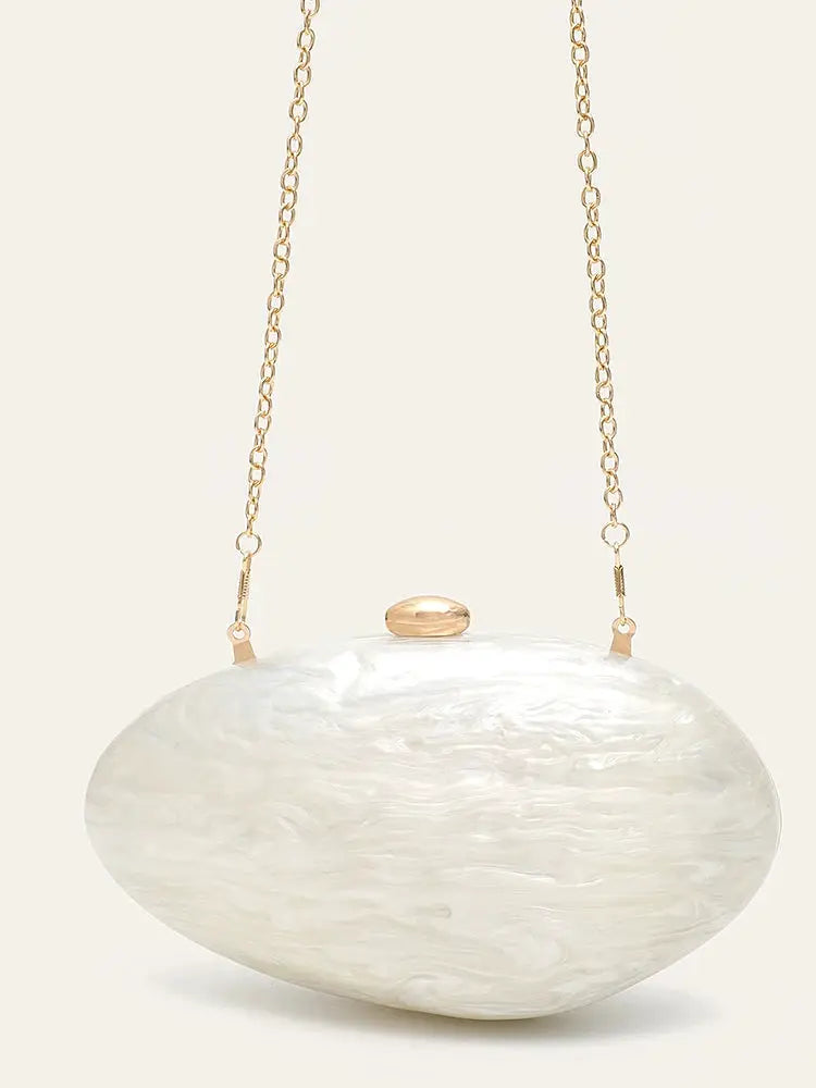 Shell-shaped acrylic clutch with pearl-white finish and long gold chain evening bag