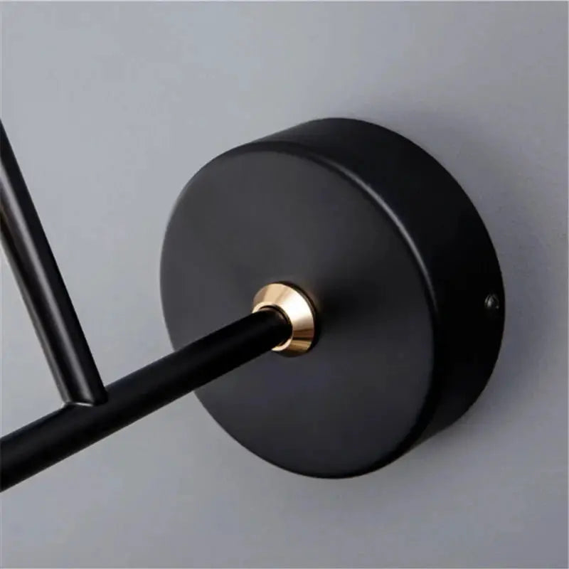 Modern LED wall lamp with matte black round backplate and brass accent collar