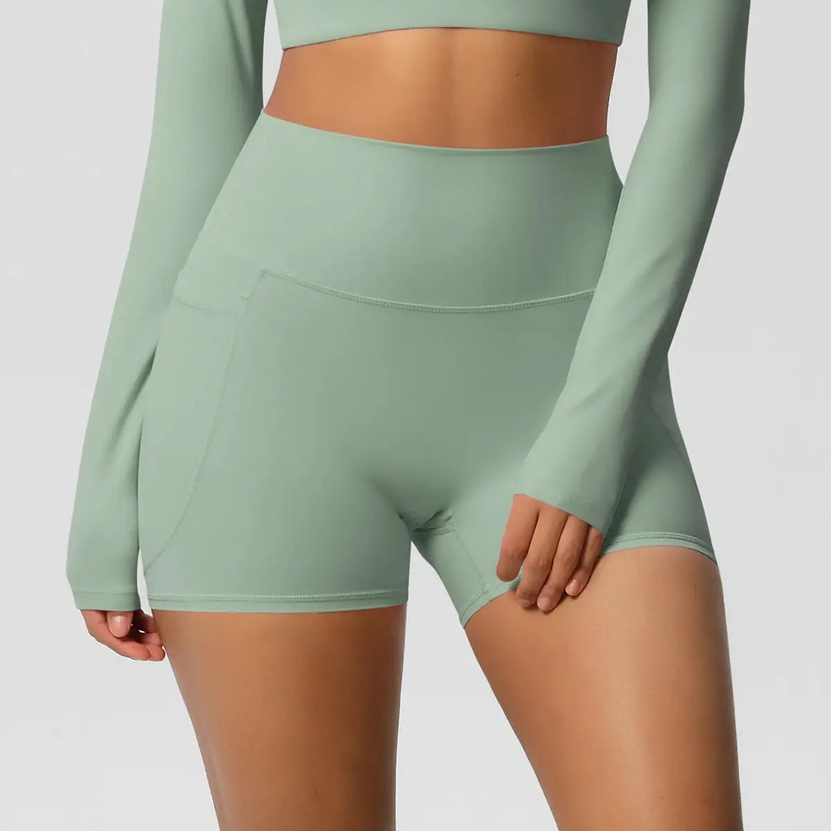 Women pocketed yoga shorts in mint green, high-waist quick-dry athletic shorts