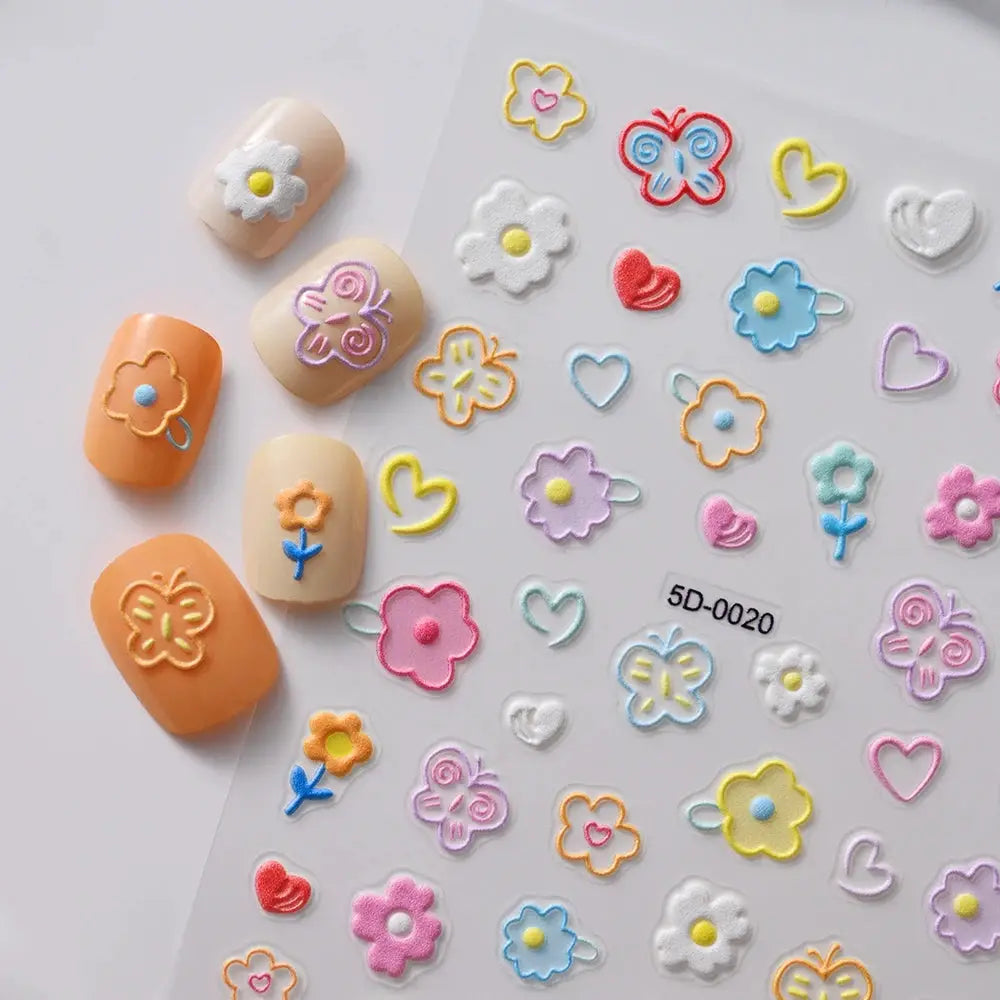Sheet of 5D macaron flower nail charms and decals with pastel embossed flowers, hearts and butterflies