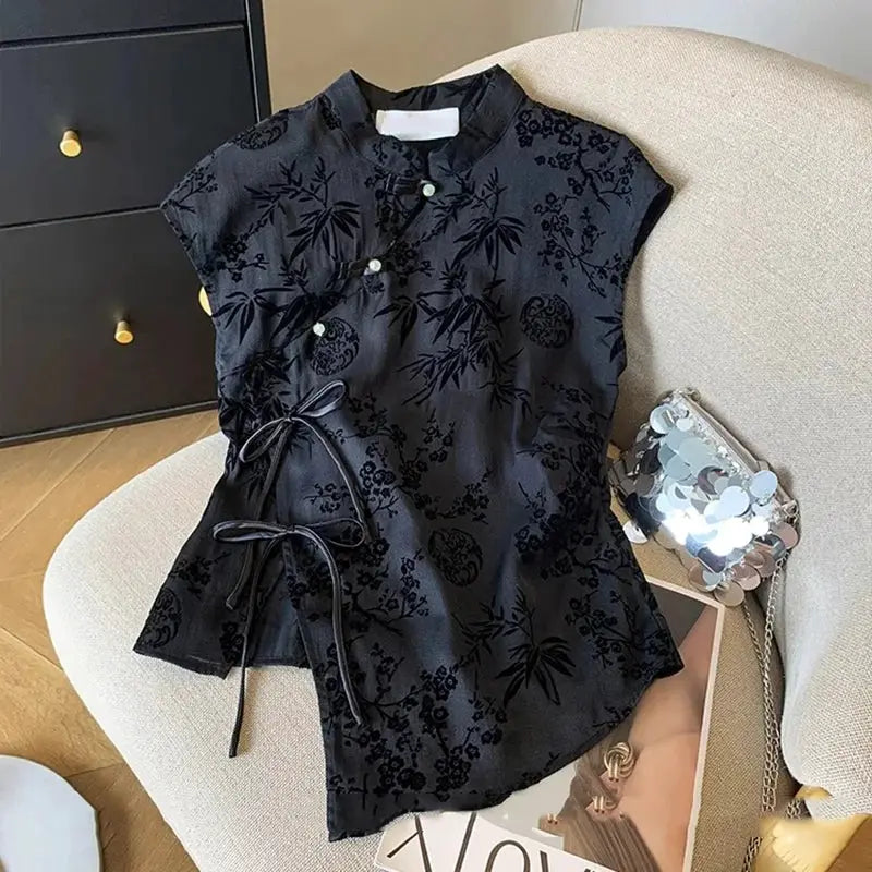 Cheongsam-style black jacquard top with floral bamboo pattern, short sleeves and a waist tie
