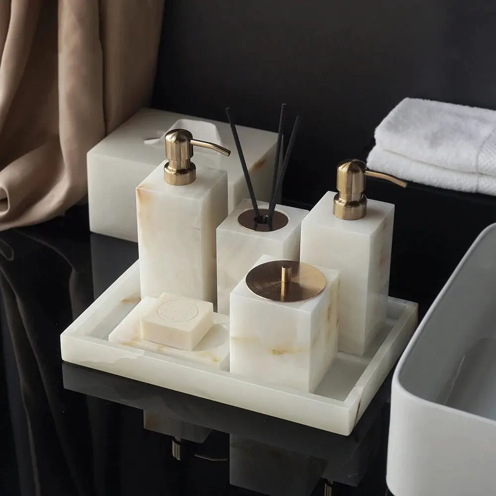 White onyx marble bathroom set by Simples Market; with gold soap dispensers, tissue box, vanity tray, and soap dish