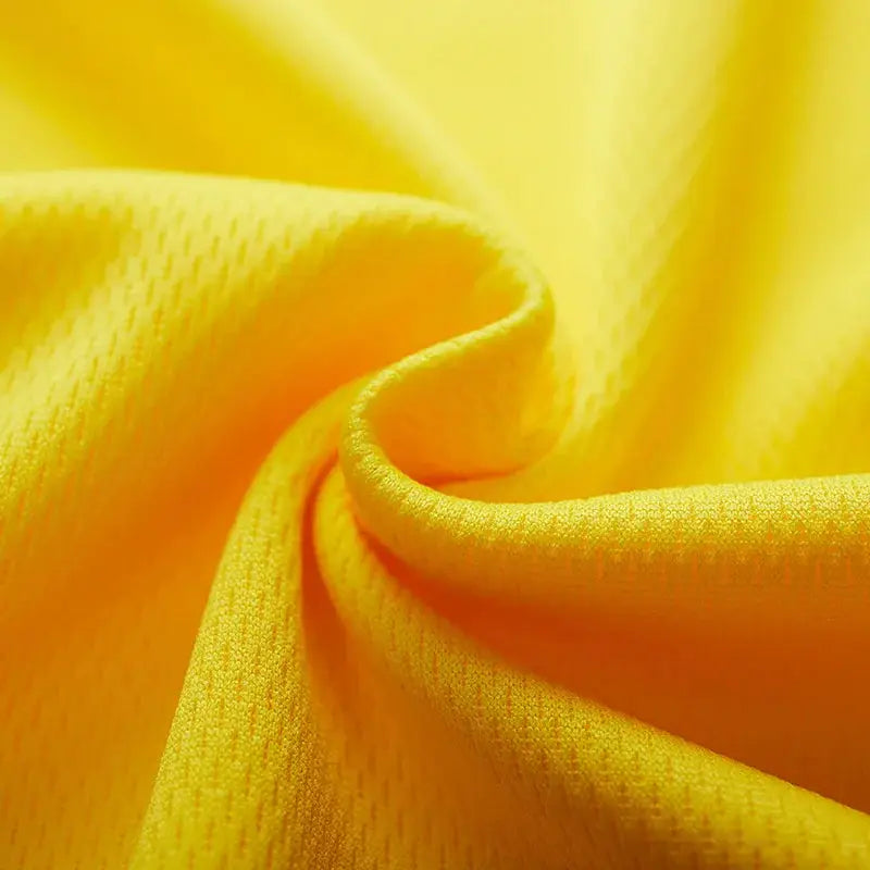 Yellow quick-dry running jersey fabric close-up with textured knit.